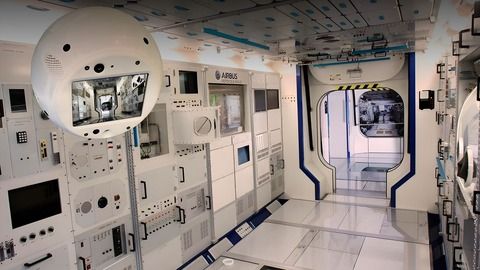 Astronaut interacting with an artificially intelligent robot on the International Space Station